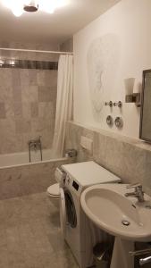 a bathroom with a washing machine and a sink at Königliche Villa Appartement mit Balkon in Berchtesgaden