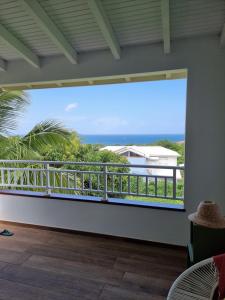 a balcony with a view of the ocean at Les hauts du Morne Larcher in Quartier du Fond Fleuri