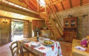 a kitchen and dining room with a table and a staircase at Stunning Home In Casoli Lu With 2 Bedrooms in Cocciglia