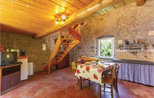 a kitchen and dining room with a table and a staircase at 2 Bedroom Stunning Home In Casoli Lu in Cocciglia