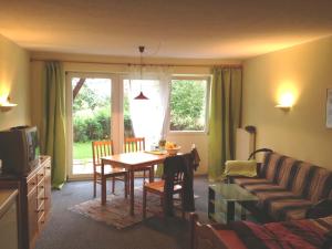 a living room with a table and a couch at Ferienhäuser Schlossberg in Zandt