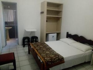 a bedroom with a large bed and a bathroom at Hotel Mariluz in Imbé +35 photos