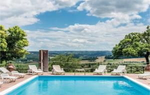 a pool with chairs and a view of the countryside at Amazing Apartment In Castiglione D,lago Pg With 2 Bedrooms, Wifi And Outdoor Swimming Pool in Strada