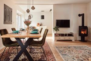 a dining room with a table and a fireplace at AVA HOUSE in Podkoren