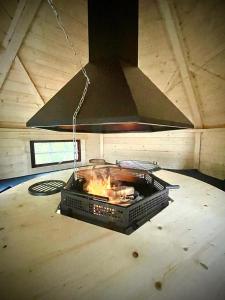 a stove in the middle of a room at Villa 250m2 avec PISCINE chauffée & SPA & kota-grill & sauna in Saint Die