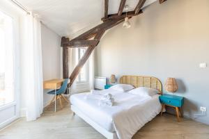 Кровать или кровати в номере Le Panorama
