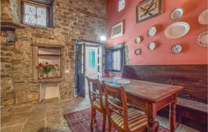 a dining room with a wooden table and a brick wall at Amazing Home In Comano ms With 1 Bedrooms, Sauna And Wifi in Comano