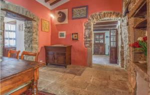 a room with orange walls and a wooden table at Amazing Home In Comano ms With 1 Bedrooms, Sauna And Wifi in Comano