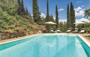 a swimming pool with chairs and umbrellas at San Martin in Morra