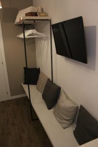 a bunk bed with pillows and a tv on a wall at St. Peter's Luxury Rooms in Rome