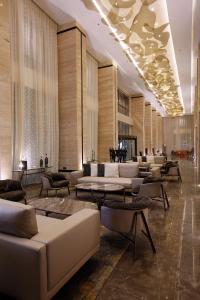 a lobby with couches and tables in a building at Grand Plaza Hotel - Jazan in Jazan