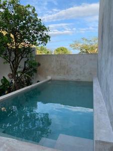 a swimming pool in the side of a house at Private Full House with pool and cozy patio in Valladolid