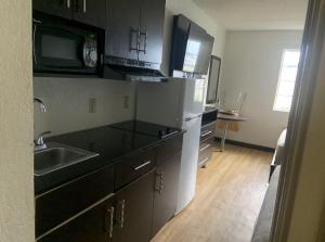 a kitchen with a sink and a counter top at Extended Stay Pensacola in Pensacola
