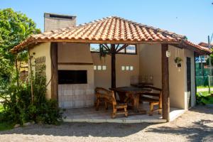 a gazebo with a table and chairs on a patio at Residencial Villa Luana in Garopaba +11 photos
