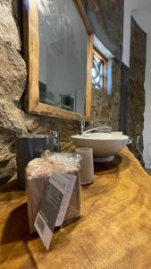a stone bathroom with a sink and a counter with a counter at Dune Towers in Alankuda