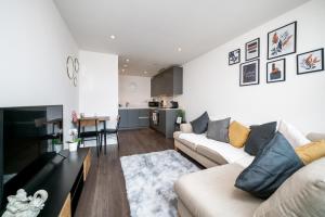 a living room with two couches and a table at Croydon Saffron Mordern Apartment in Croydon