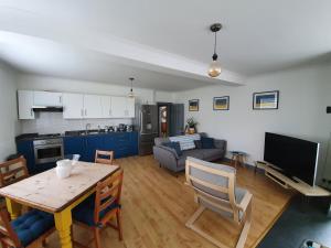 a kitchen and living room with a table and a couch at The Annex Dymchurch in Dymchurch