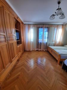 a bedroom with a bed and a wooden floor at Dworek nad Potokiem in Karpacz