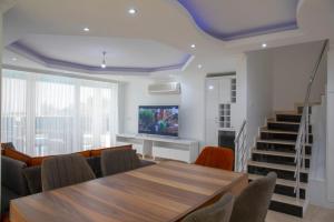 A television and/or entertainment centre at Sunrise hill villa with private pool