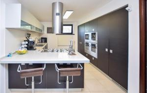 a kitchen with a white counter and black cabinets at Lovely Home In Velletri With House A Panoramic View in Velletri