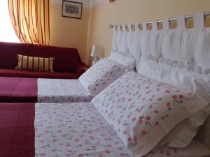 a bedroom with a bed and a couch at Sa Chessa B&B in Ploaghe