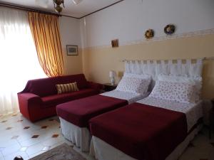 a hotel room with two beds and a couch at Sa Chessa B&B in Ploaghe