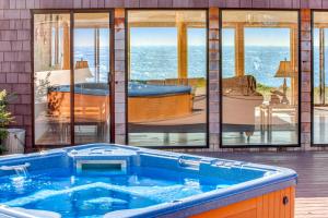 a hot tub in a house with a view of the ocean at Seascape in Sea Ranch