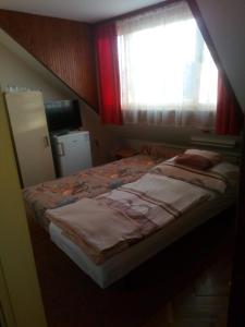 Кровать или кровати в номере Agria Retur Vendégház