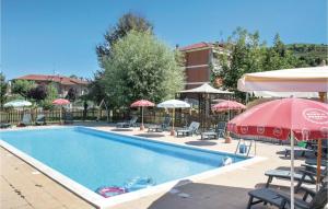 a swimming pool with chairs and umbrellas at Le Rocche 1 in Cisterna dʼAsti