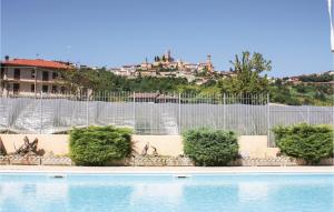 a fence next to a swimming pool with at Le Rocche 1 in Cisterna dʼAsti