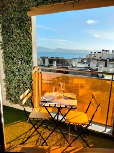 a table and chairs on a balcony with a view at Apartamento Sanxenxo Carles Deluxe Ocean View in Sanxenxo