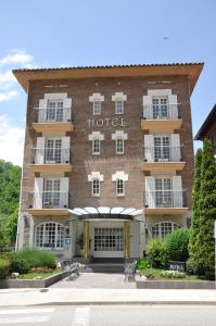 a hotel with a sign on the side of it at Hotel Edelweiss in Camprodon