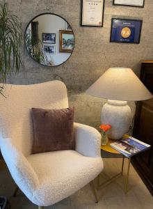 a living room with a chair and a lamp at Pensiunea Marylou in Alba Iulia