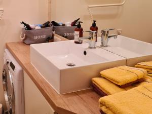 a bathroom with a white sink in a room at M.K. Čiurlionis 7 in Vilnius +12 photos