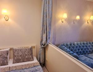 a room with a blue couch and two pillows at M.K. Čiurlionis 7 in Vilnius