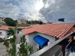 a view of a house with a blue roof at Hostel flor do Caribe in Natal