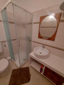 a bathroom with a toilet and a sink and a mirror at Apartments Božena in Pakoštane