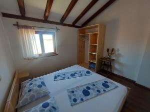 a bedroom with two beds and a window at Apartments Božena in Pakoštane