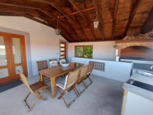 a dining room with a wooden table and chairs at Apartments Božena in Pakoštane