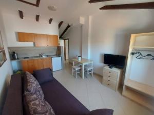 a living room with a couch and a kitchen at Apartments Božena in Pakoštane