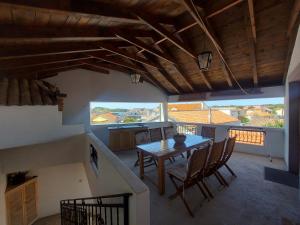 a kitchen with a table and chairs in a room at Apartments Božena in Pakoštane