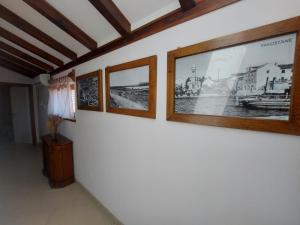 a hallway with three pictures on the wall at Apartments Božena in Pakoštane