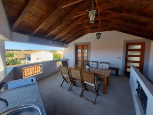 a kitchen and dining room with a table and chairs at Apartments Božena in Pakoštane