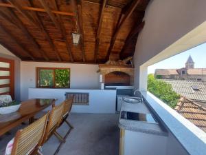 a kitchen and dining room with a table and benches at Apartments Božena in Pakoštane