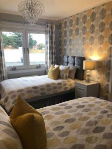 a bedroom with two beds and a window at Skerrols in Broadford +56 photos
