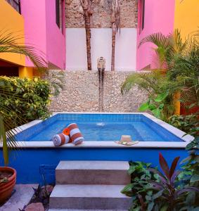 a swimming pool with a beach ball and a toy at Art 57 Hotel - Adults Only in Mérida