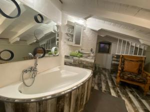 a bathroom with a large white tub in a room at Boomhuisie in Komatipoort +59 photos