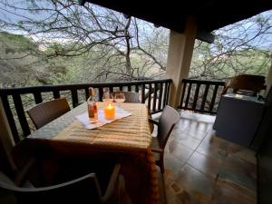 a table with a candle on top of a balcony at Boomhuisie in Komatipoort