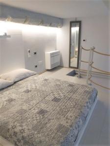 a bedroom with a large bed and a mirror at La Casa di Tommy in Rapallo