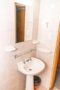 a bathroom with a sink and a mirror at Tacuifi I - Cabañas in Los Reartes